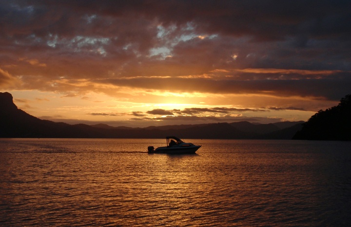 Boat on Lake Waikaremoana at sunset, New Zealand