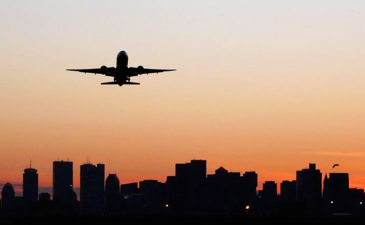 Plane taking off at sunset