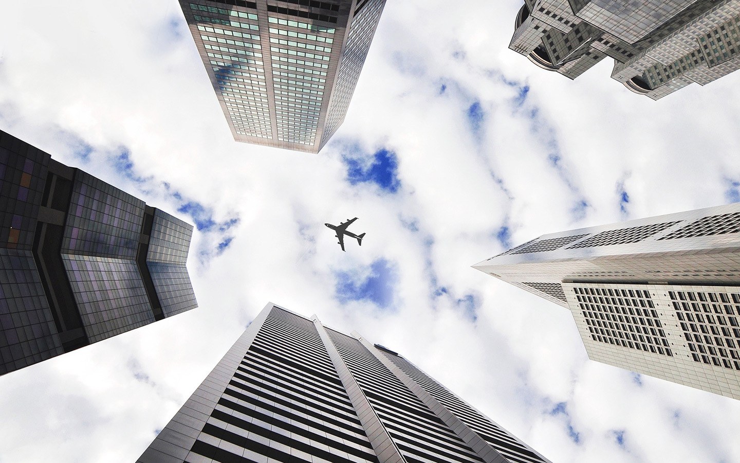 Plane flying above skyscrapers